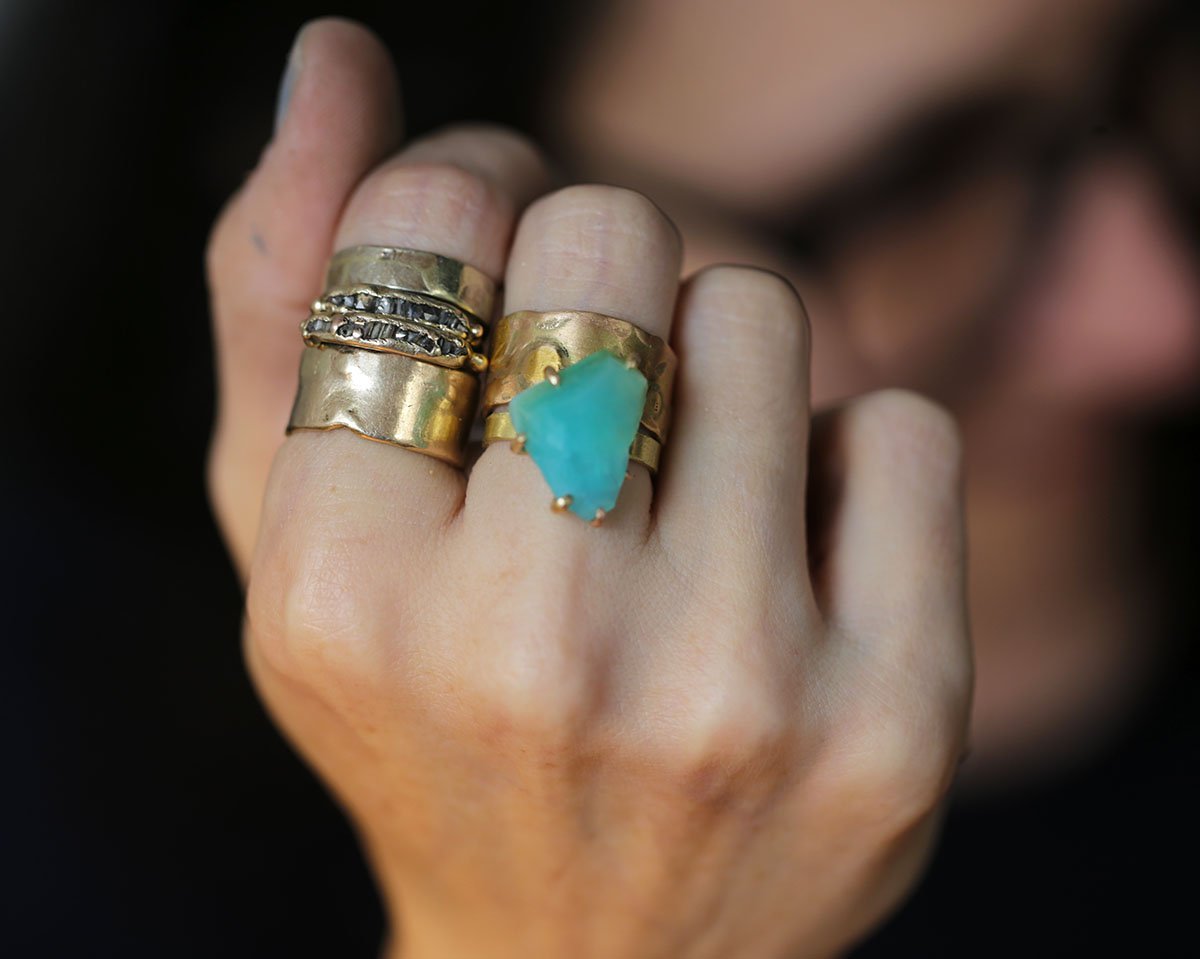 Peruvian Opal and cigar band rings on hand