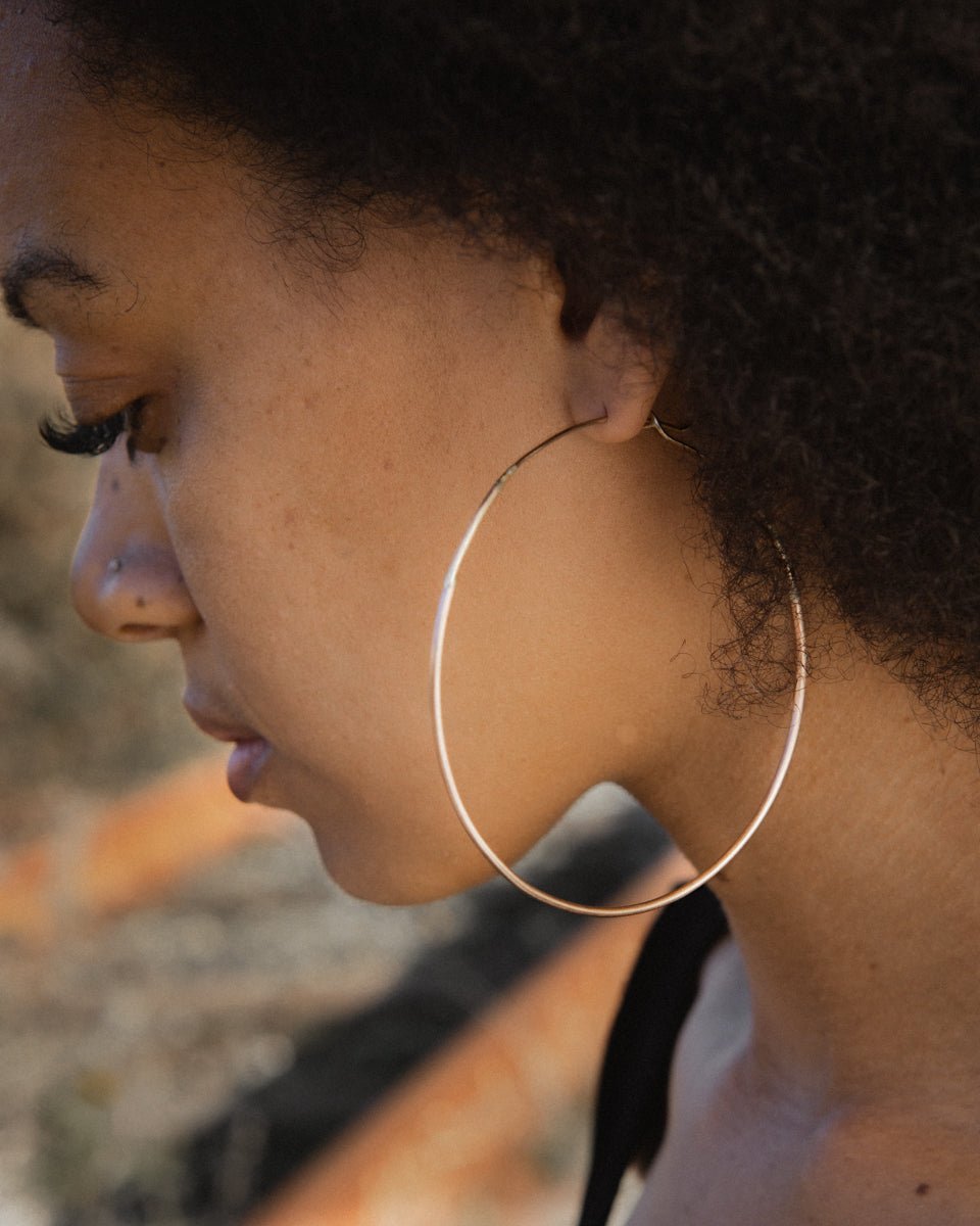 Lady wearing gold ombre hoop earrings