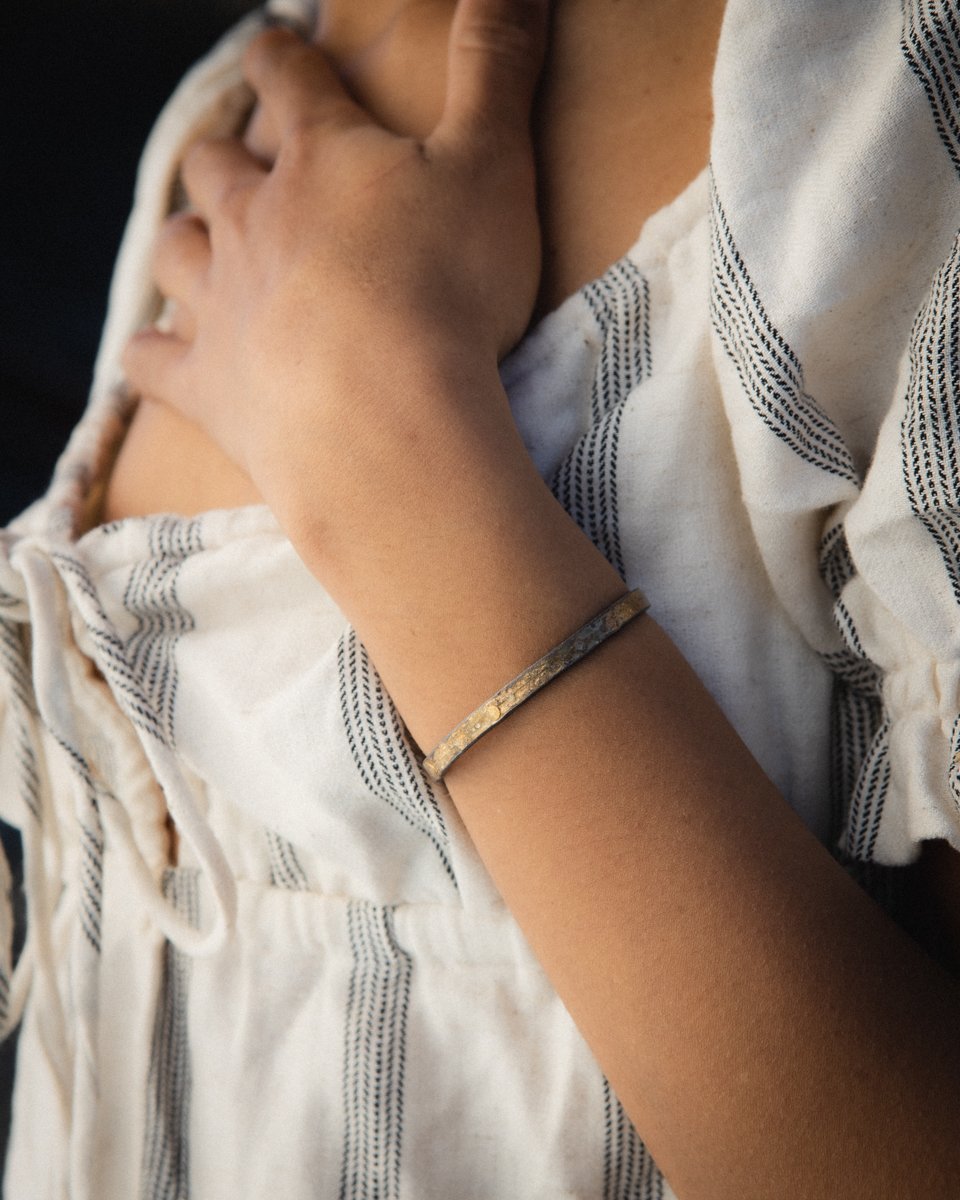 Lady wearing silver and gold seamed cuff