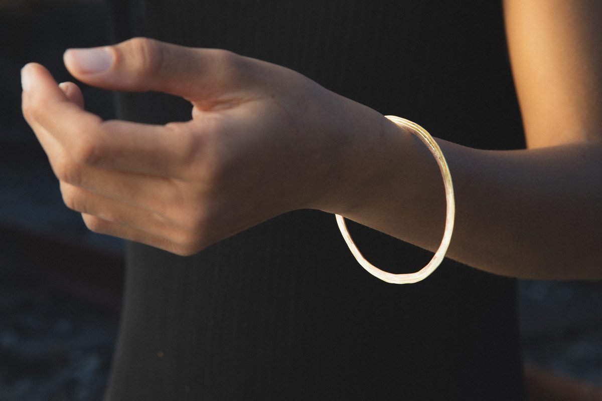 Lady wearing high carat ridge bangle