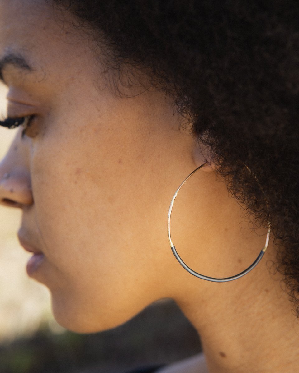 Lady wearing small mixed gold and silver ombre hoops