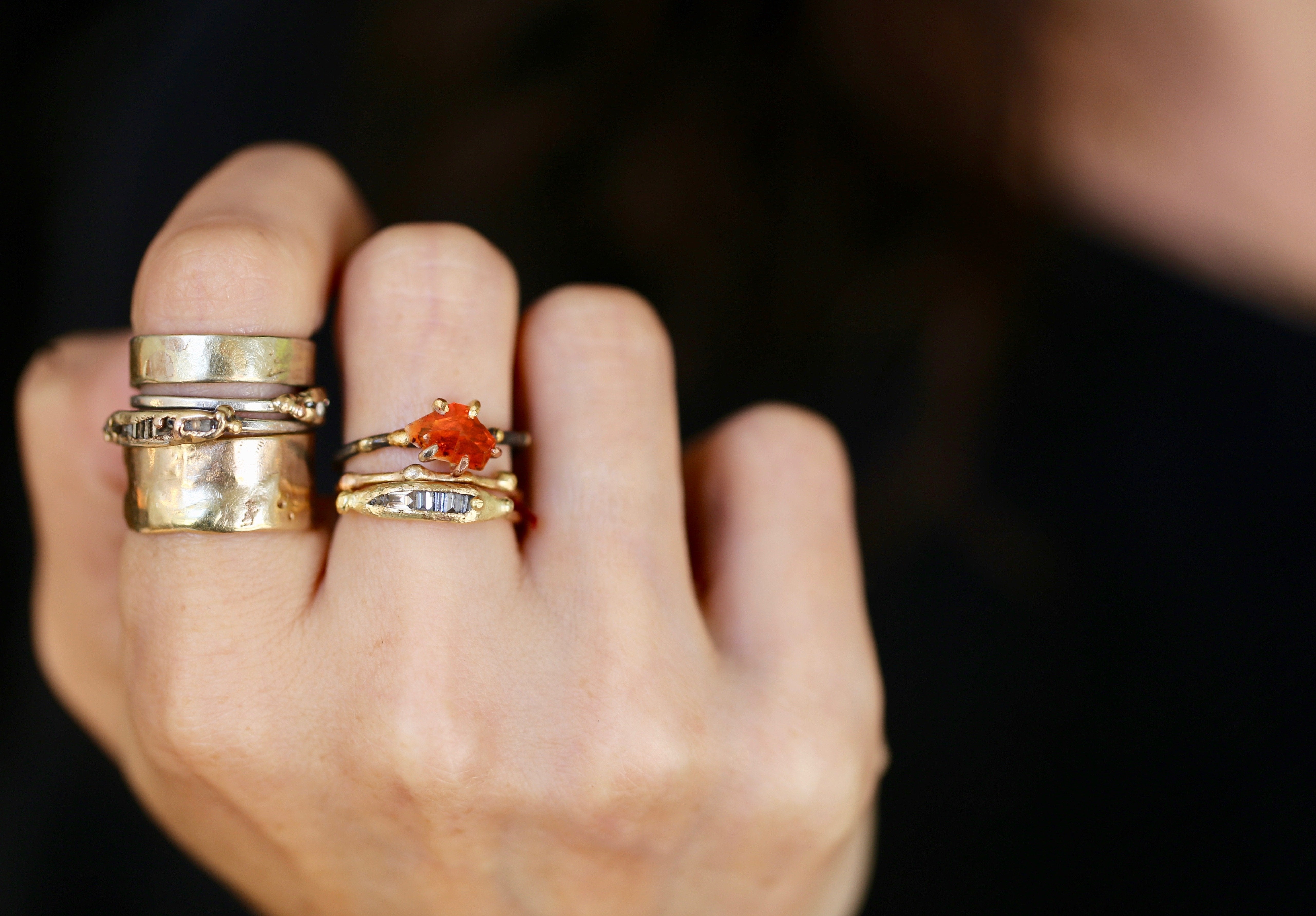 Mexican Fire Opal and baguette diamond rings on hand