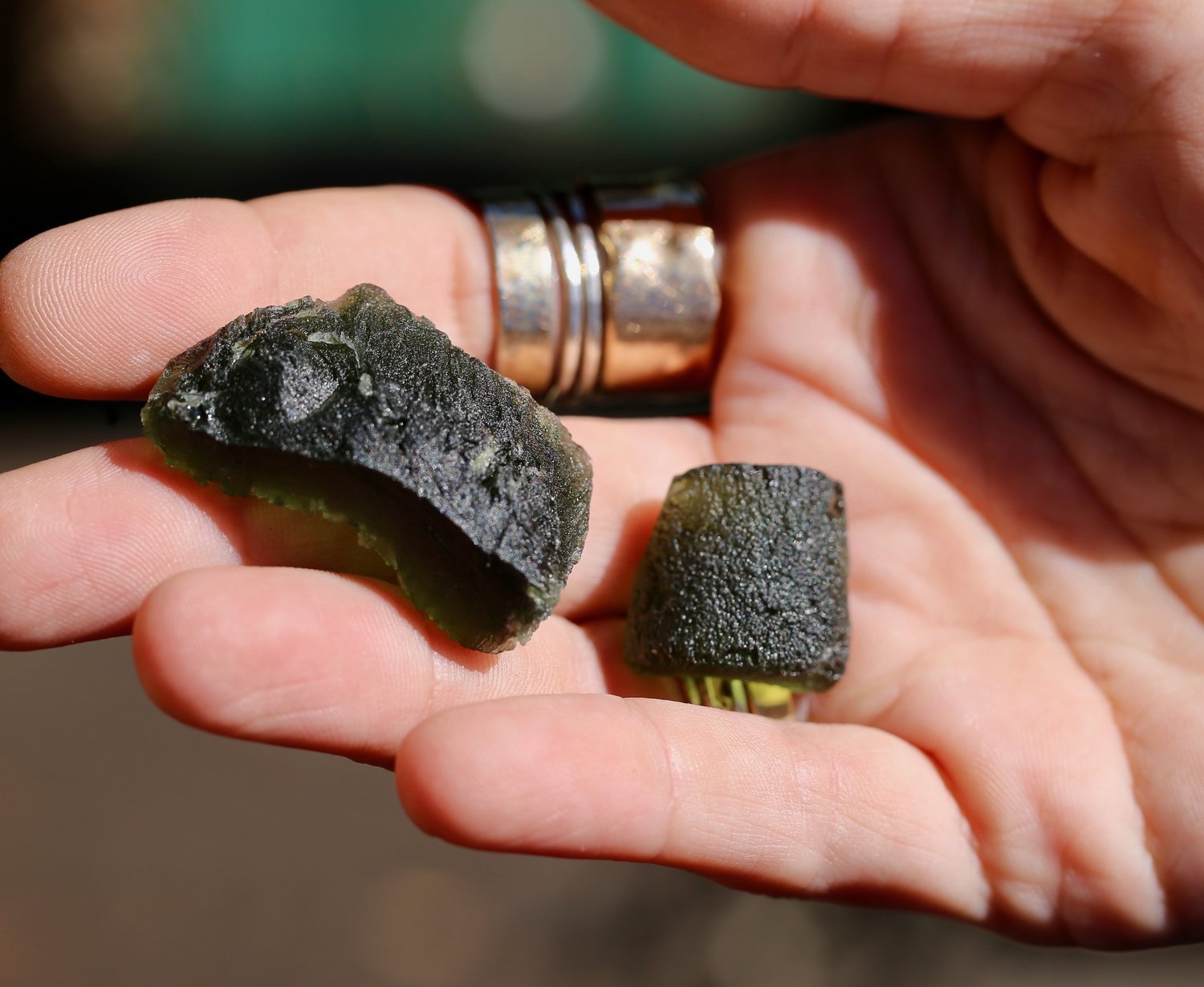 Rough Moldavite in hand