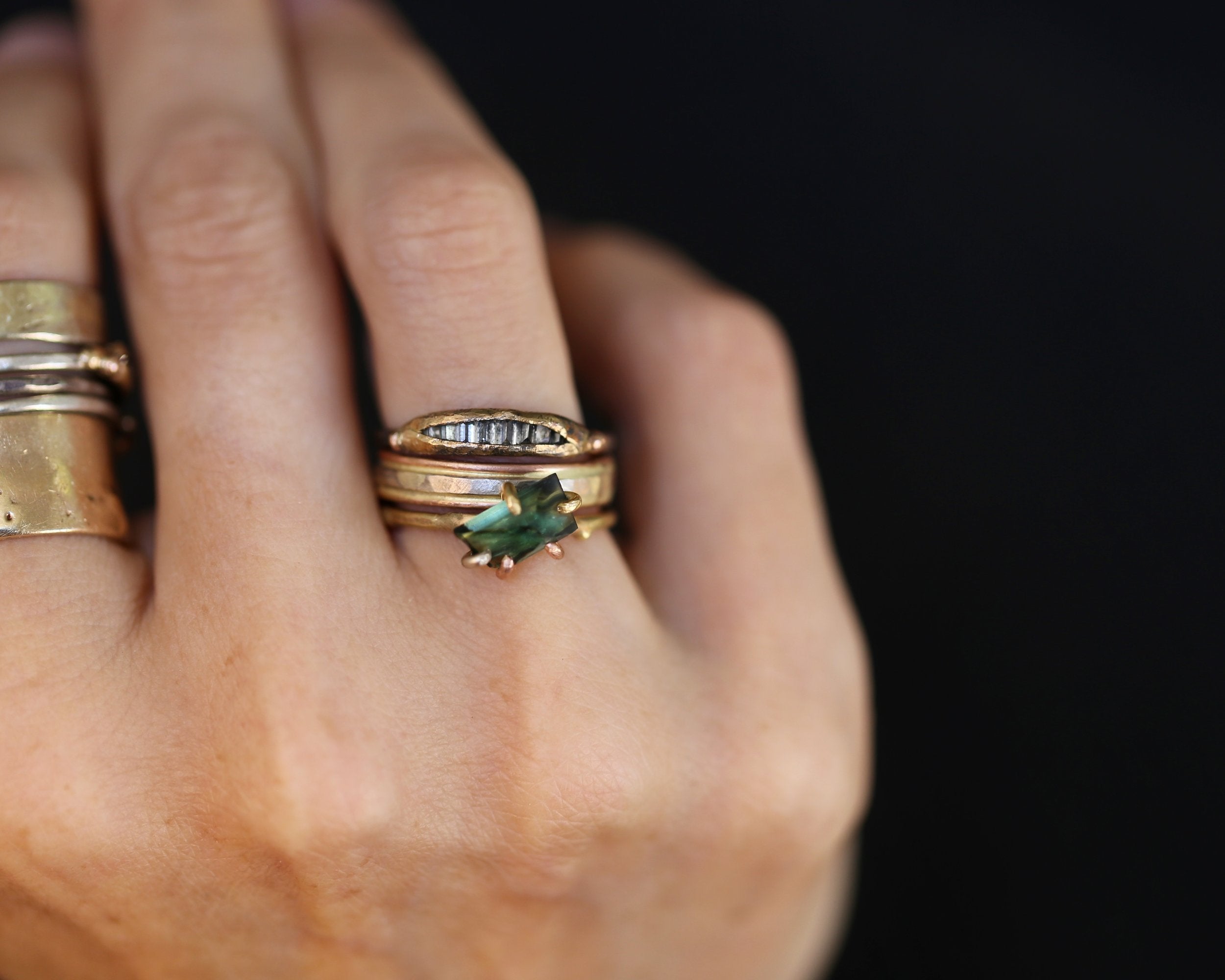 Tourmaline and diamond rings on hand