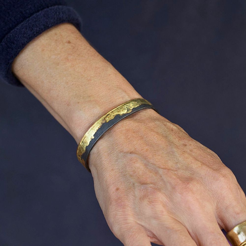 Gold edge cuff with oxidized silver bracelet