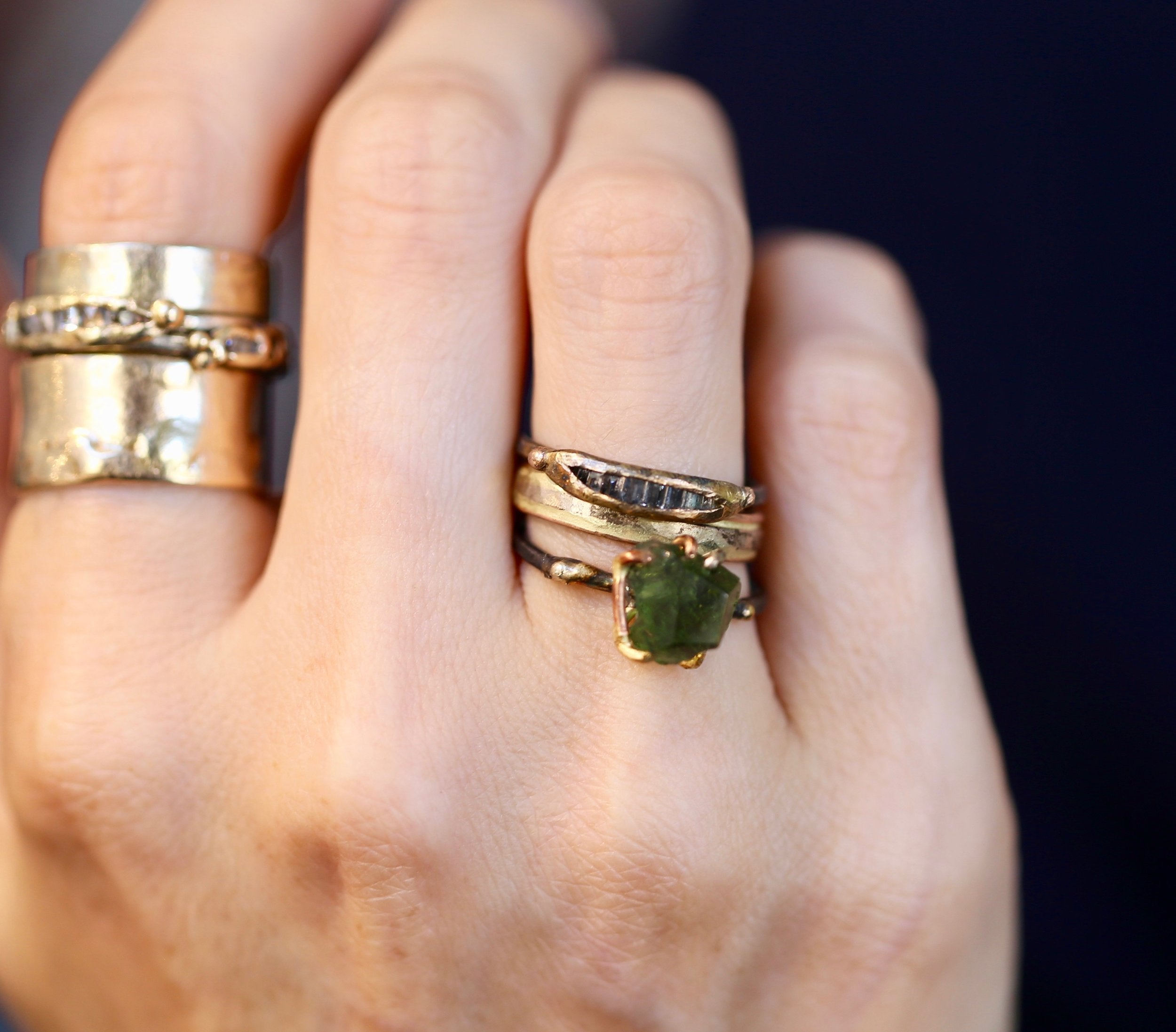 Moldavite ring and diamond ring on hand